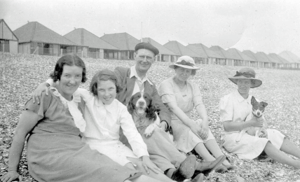 Mum, Len, Dad, Hector the dog, and possibly two cousins of Dad's from Lancacashire. Unknown beach, but probably on the East or South East English coast