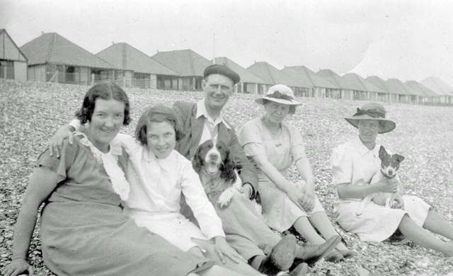 Mum, Len, Dad, Hector the dog, and possibly two cousins of Dad's from Lancacashire. Unknown beach, but probably on the East or South East English coast