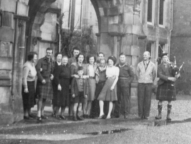 "Group at Auchendrennan New Year's Day, 1947. Dad and Mum at left and right. Mrs Mac is in Centre with Henry Lindsay at her back - that's Henry's brother in kilt next to me. The piper appeared playing a tune, he had walked all the way from Tarbert after playing all night!" Mums annotation on back of photo.